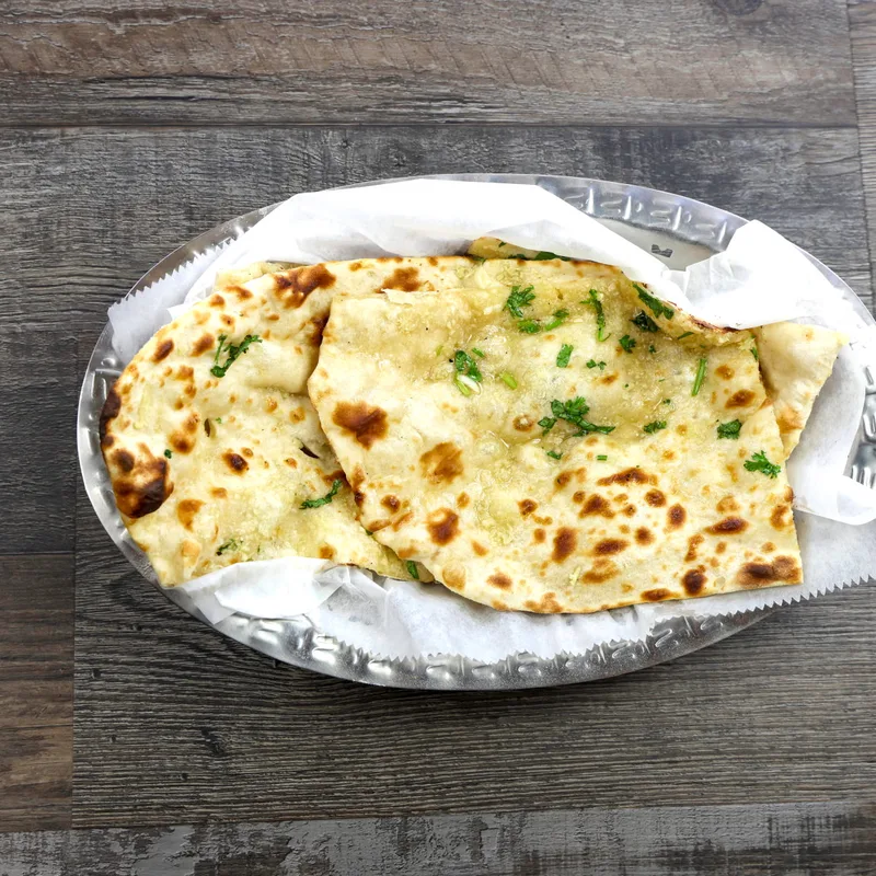 Fresh garlic naan in a basket